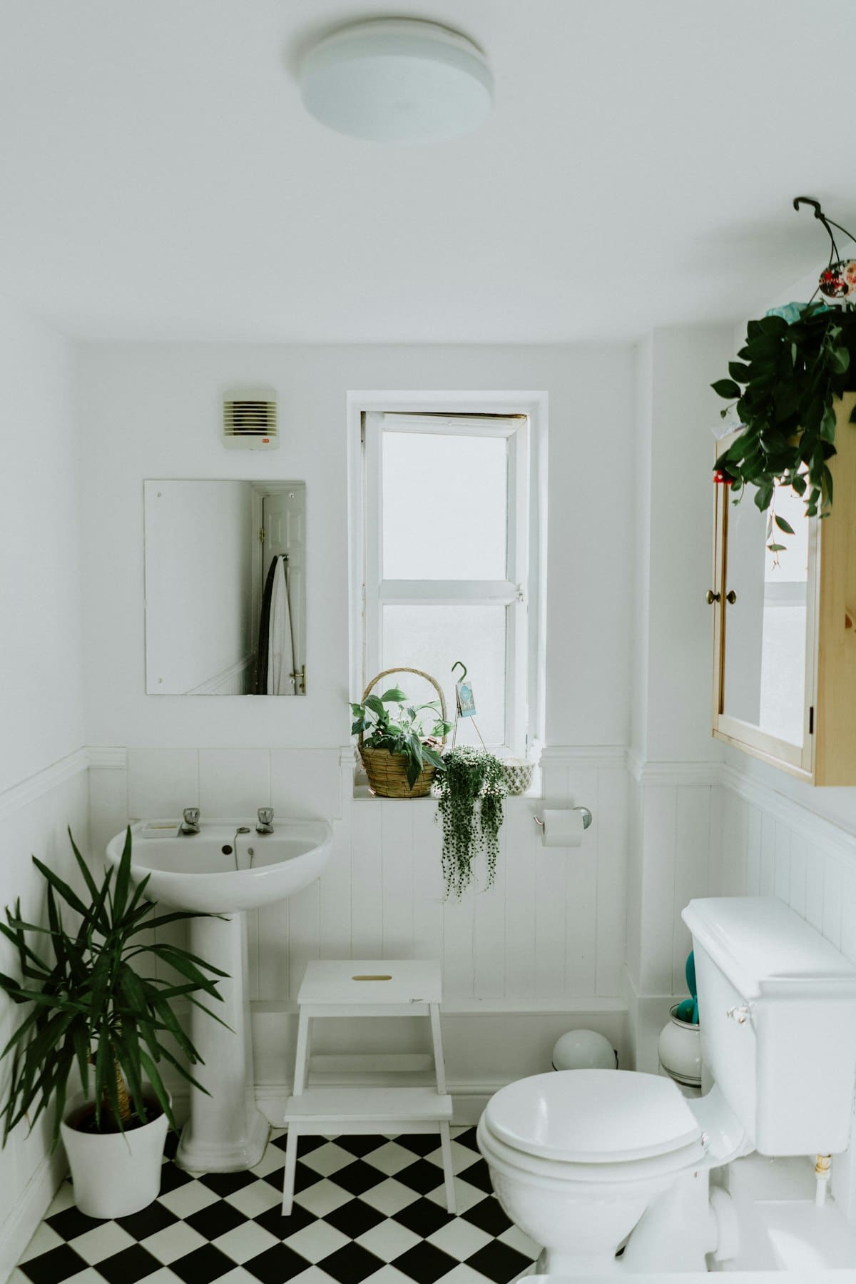 Serene small bathroom retreat with warm amber lighting, plush textured towels, and natural wood accents