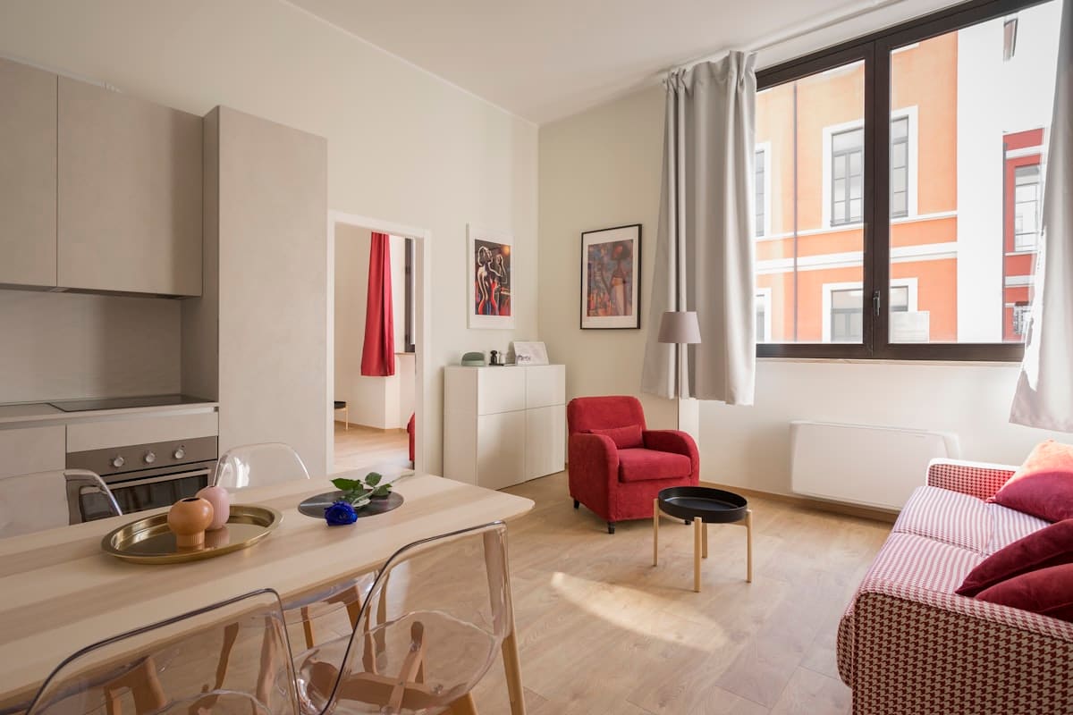 Compact apartment living and dining zone with clear walking paths, warm neutral styling, and multifunctional furniture